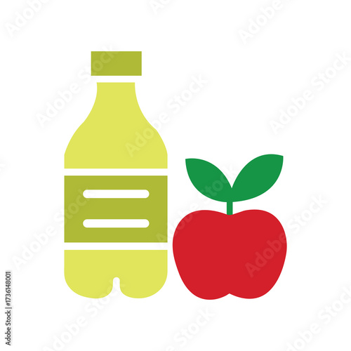Yellow apple juice bottle rests near a red apple against a white background
