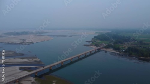 Wallpaper Mural Drone shot of a river crossing a bridge in the afternoon sunset  Torontodigital.ca