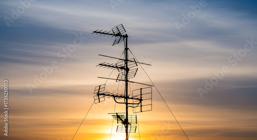 Artistic Photo of Rooftop Antenna Creating Symbolic Silhouette in Warm Light