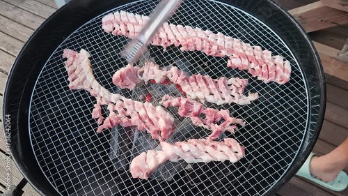 Korean BBQ style. Asian grilling barbecue on mesh grill of charcoal fire. Korean traditional food.