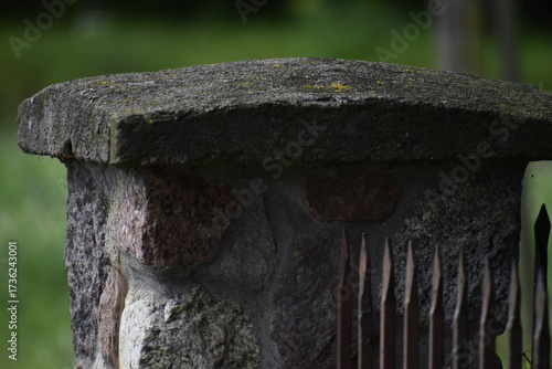 Fence post with metal railing of vertical bars