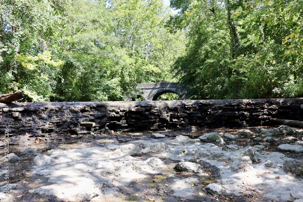 Obraz premium The dried up waterfall in the creek at the park.