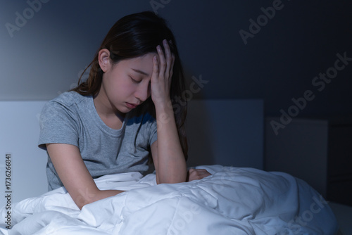 Sad worried and stressed, depressed asian young woman, girl suffering in bed from insomnia problem, awake at night, hand covering face from trouble disturbed loud noise, unable sleep. Restless people.
