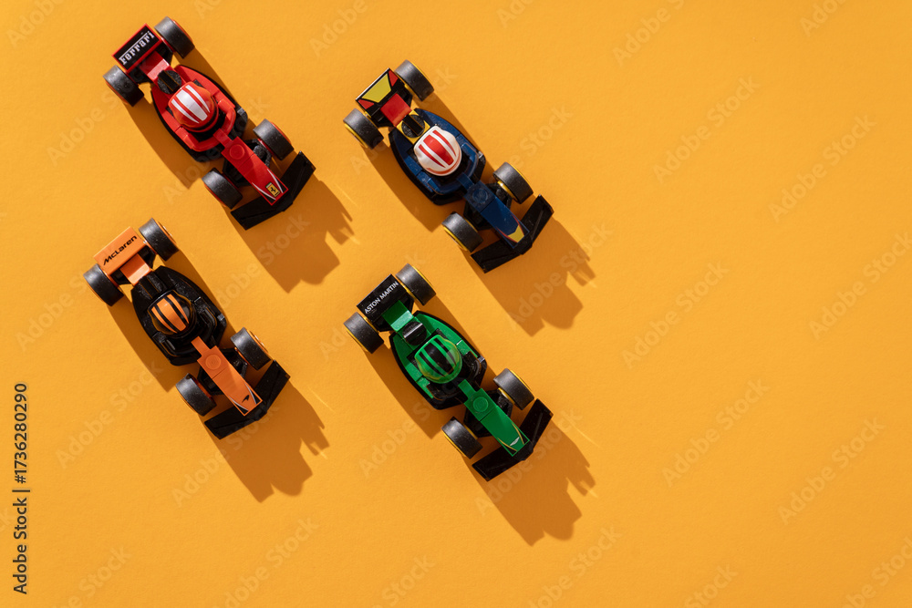 Fototapeta premium Ukraine, Kyiv - September 18, 2025: Toy car Formula 1 Lego set. Ferrari, Aston Martin McLaren formula one team race game. Top view background
