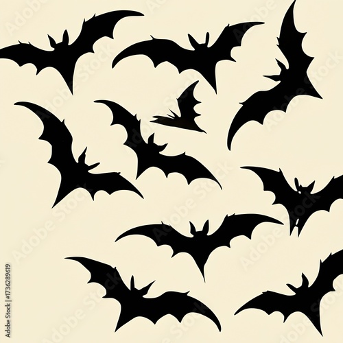 Decorative black bat cutouts artfully arranged in a dynamic flying pattern, appearing to swoop down from the sky, creating a sense of atmospheric Halloween or spooky decor.