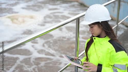 Engineer inspecting wastewater treatment plant and recording data for environmental monitoring. Concept of water management, industrial inspection, and sustainability process.
