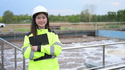 Engineer inspecting wastewater treatment plant and recording data for environmental monitoring. Concept of water management, industrial inspection, and sustainability process.
