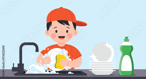 A happy young boy wearing an orange cap happily washes dishes in a kitchen sink full of soap suds.