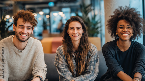 Team of three professionals in coworking lounge area