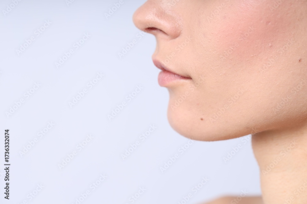 Obraz premium Woman with normal skin on light background, closeup. Space for text