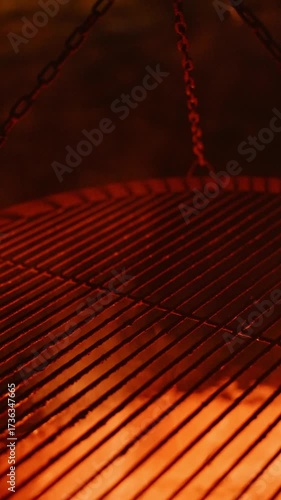 A beautifully illuminated grill featuring vibrant flames and charcoal glowing underneath