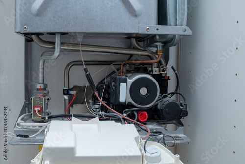 Internal Components of a Modern Gas Boiler with Circulating Pump and Wiring Exposed, HVAC System Maintenance and Repair View, Plumbing and Heating Technology Detail
