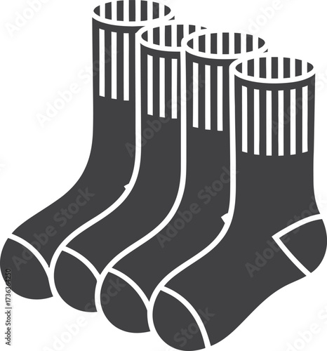 Four dark grey socks standing upright in a row