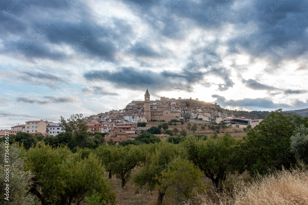 Fototapeta premium Scenic view of the historic town of Peñarroya de Tastavins, dominated by its 18th-century Baroque church, Spain.