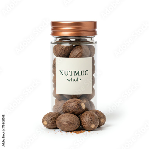 A glass jar of nutmeg on white background