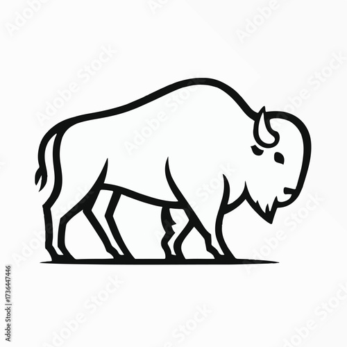 Herd of bison grazing in a vast golden prairie under a clear sky