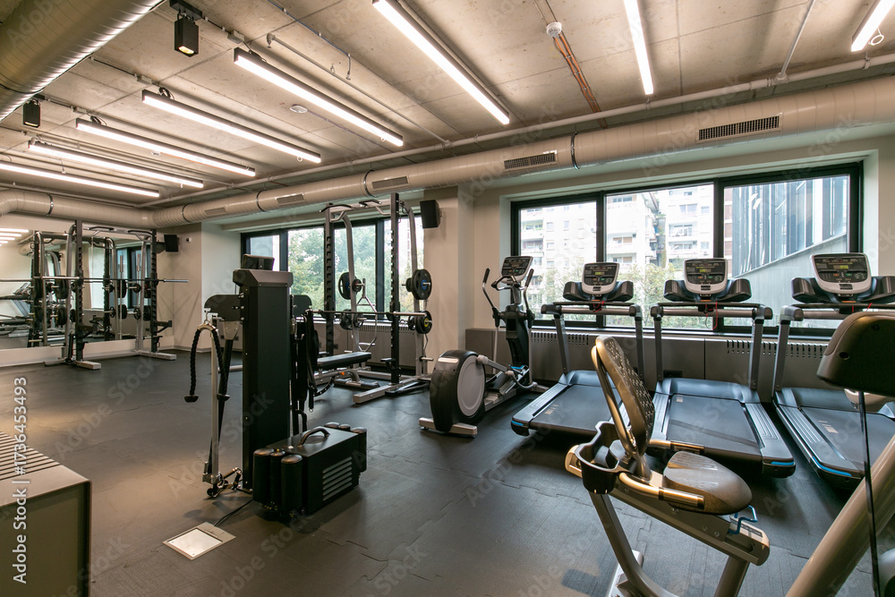 Fototapeta premium Interior of a modern hotel gym with equipment