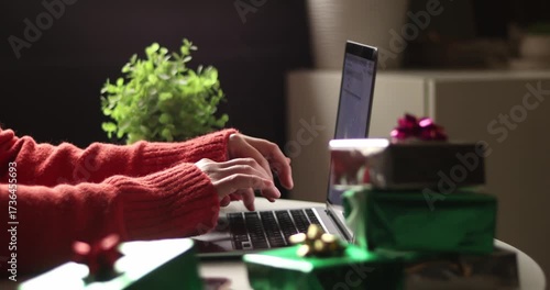 Christmas online shopping, sales and discounts promotions during winter holidays, online shopping at home. Female hands on the laptop typing and shopping new years presents