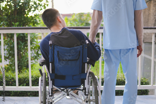 A young man with disability and a kind doctor or caregiver or volunteer, Activity in hospital , home, quarantine, Concept of Mental health, Wellness, Health and medical, rehabilitation, patient care.