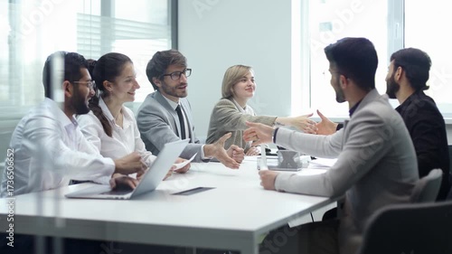 Wallpaper Mural A group of people are sitting around a table in a conference room Torontodigital.ca