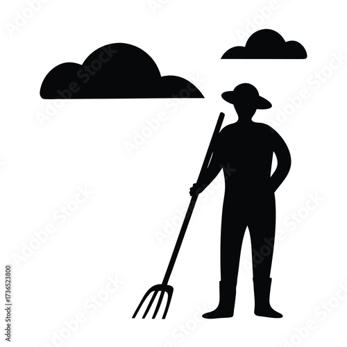 Silhouette of a farmer wearing a hat and holding a pitchfork under a cloudy sky