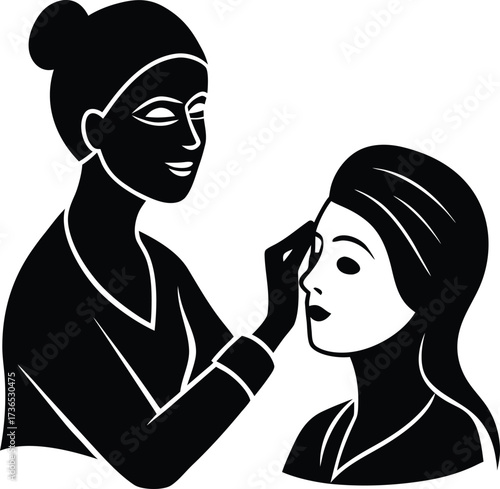 A beautician applying face mask treatment to a customer