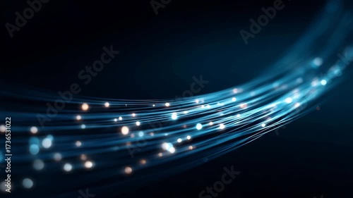 Curved blue glowing fiber optic strands with light particles in dark