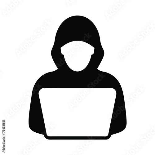 Silhouette of a hooded figure using a laptop computer representing cybercrime and online anonymity