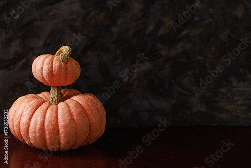 Pumpkins with copy space on dark surface. Concept of website banner, digital mockup and holiday promotion design.