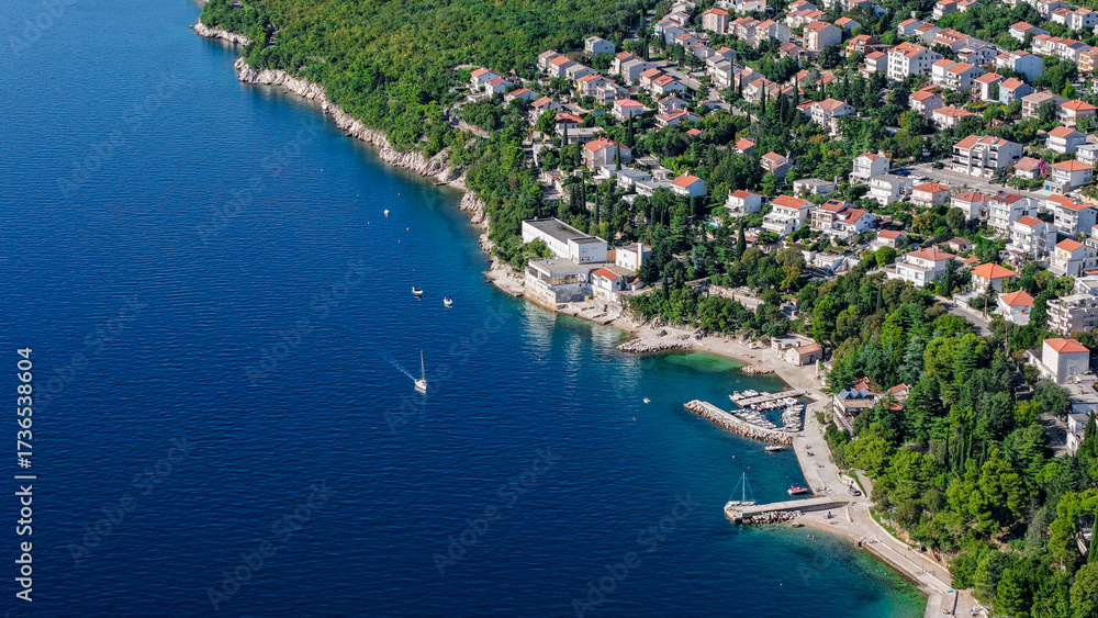 Fototapeta premium Aerial drone view of Crikvenica and Dramalj with turquoise Adriatic Sea, green-blue waters, beaches, and the island of Krk in the distance. Taken on 27.09.2025 in Dramalj, Croatia.