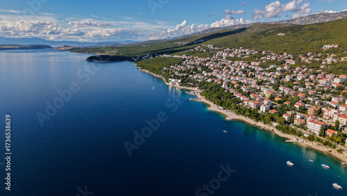 Aerial drone view of Crikvenica and Dramalj with turquoise Adriatic Sea, green-blue waters, beaches, and the island of Krk in the distance. Taken on 27.09.2025 in Dramalj, Croatia.
