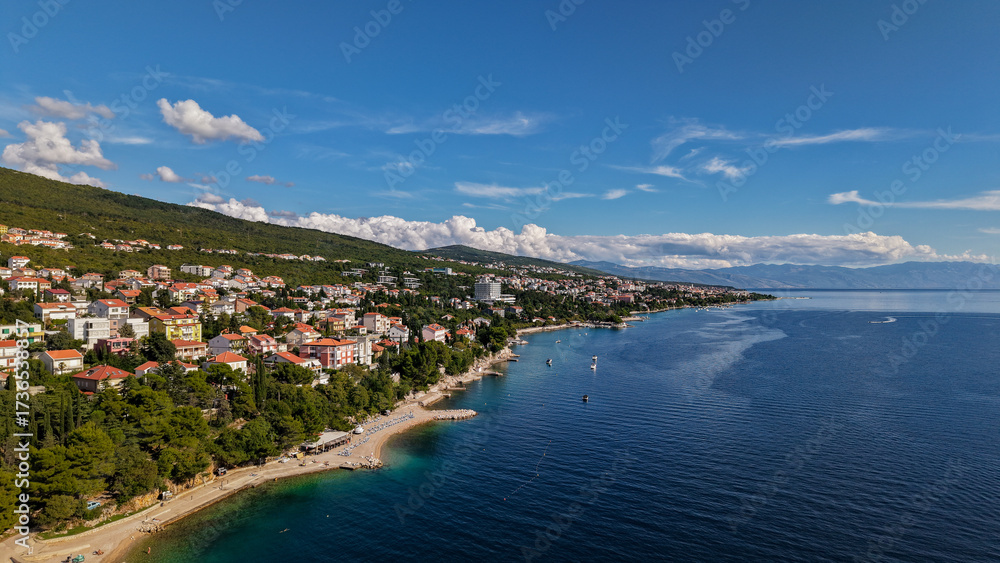 Fototapeta premium Aerial drone view of Crikvenica and Dramalj with turquoise Adriatic Sea, green-blue waters, beaches, and the island of Krk in the distance. Taken on 27.09.2025 in Dramalj, Croatia.