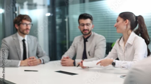 Wallpaper Mural A group of people are sitting around a table with a laptop open Torontodigital.ca