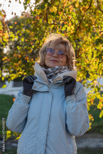 Wallpaper Mural Cheerful joyful smiling mature adult woman walking in autumn park on a sunny day. Torontodigital.ca