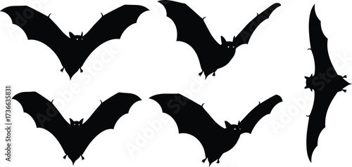 Silhouetted bats flying against a white background for halloween decorations use