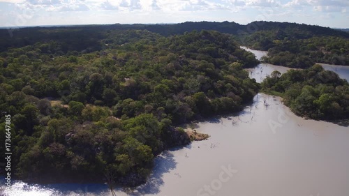 aerial view of lake in Africa, with blue water and lush vegetation, dam at low altitude, pristine ecosystem, tourist destination