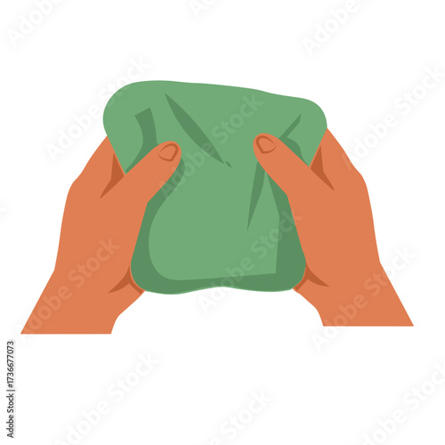 hand holding a cleaning sponge. Hands squeezing a green, stretchy material during a calm afternoon crafting session at home