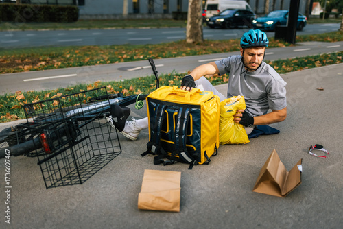 Vászonkép Fallen delivery courier with scattered packages on street