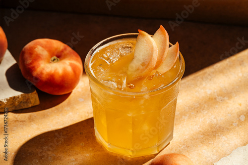 Peach drink with ice on textured stone background