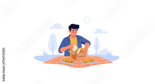Preparing Food For A Picnic, A Young Man Organizes Sandwiches and Snacks Outdoors