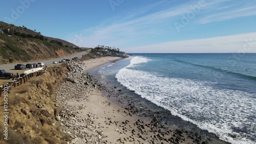 A woman walking toward the ocean to enjoy the beautiful view at Conty line beach Malibu Los Angeles California 