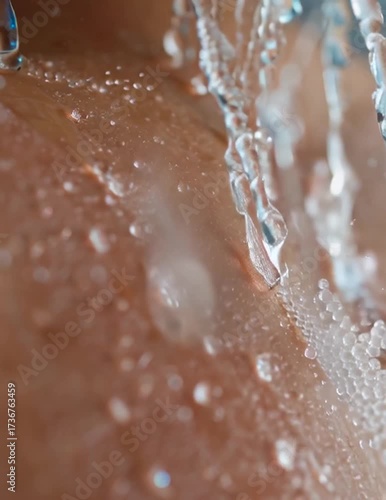Close up of water droplets cascading on skin macro shot