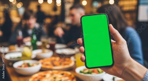 Display your innovative app or message on this sleek smartphone with a customizable green screen, perfect for engaging content in a restaurant.