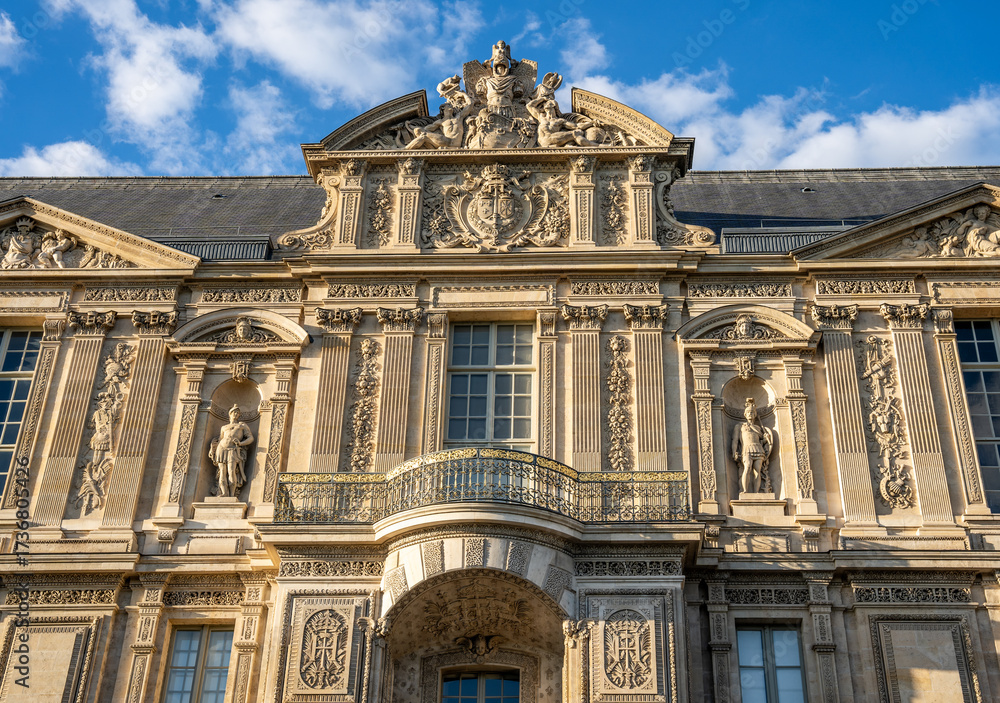 Obraz premium Exterior view of the Louvre Palace along the River Seine on Quai Francois Mitterrand, historic architecture in the heart of Paris, France.