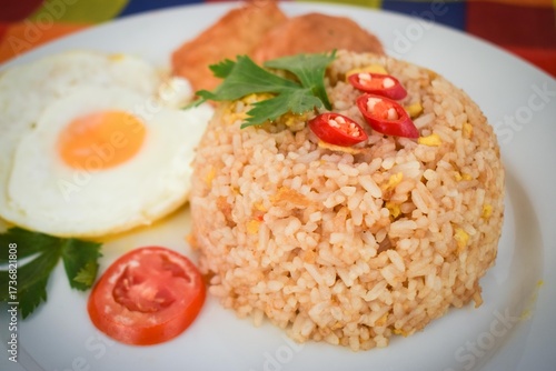 Traditional Indonesian Fried Rice with Fried Egg on White Plate.