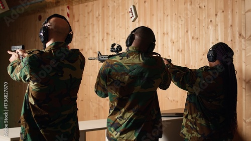 Team of soldiers wearing uniform in firing range doing shooting course to elevate marksmanship skills. Military units in shooting gallery using weapons to engage targets at various ranges, camera A