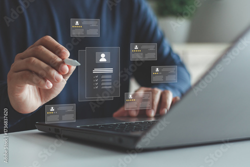 Businessman hand reviewing digital candidate profile with rating stars and checklist on laptop, concept of recruitment, job evaluation, performance review, human resources, HR and hiring process.