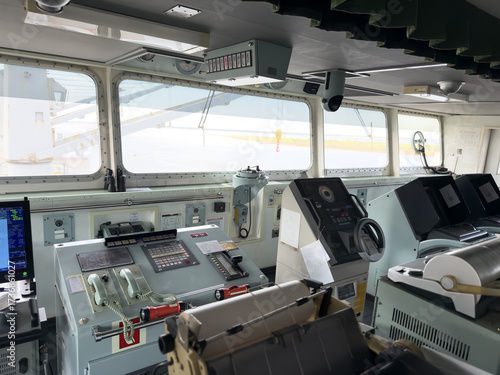 navigation bridge of the cargo ship, cockpit. navigation equipment, charts, radars, engine telegraph, communication, wheel and steering gear 21