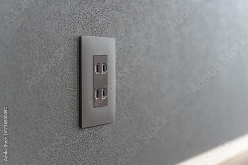 Black wall power outlet in stylish modern interior design