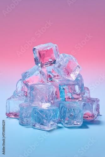 A pile of transparent ice cubes is illuminated with a gradient pink and blue backdrop